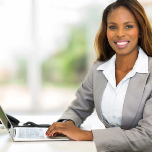 happy young african american businesswoman using computer in office